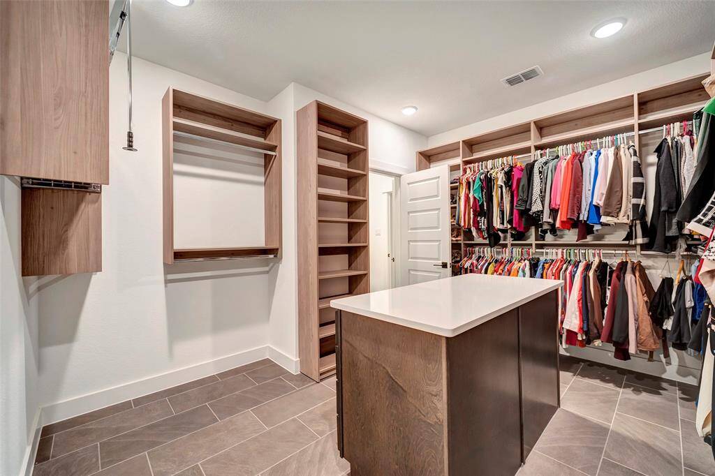 This beautifully finished closet has a variety of storage options.