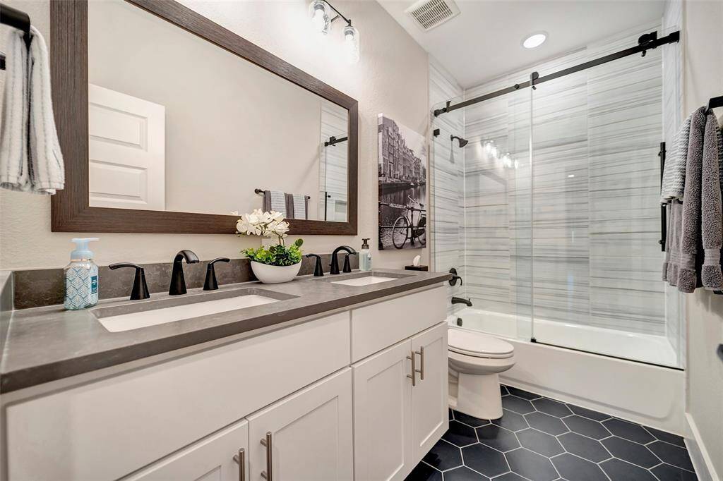 Secondary bathroom is stunning. It offers double sinks and a frameless shower with beautiful tile finishes on both walls & floors.