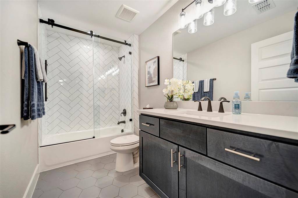 Our 3rd full bathroom completes the 3rd floor. It features a frameless shower, elegantly finished cabinetry & quartz countertops.