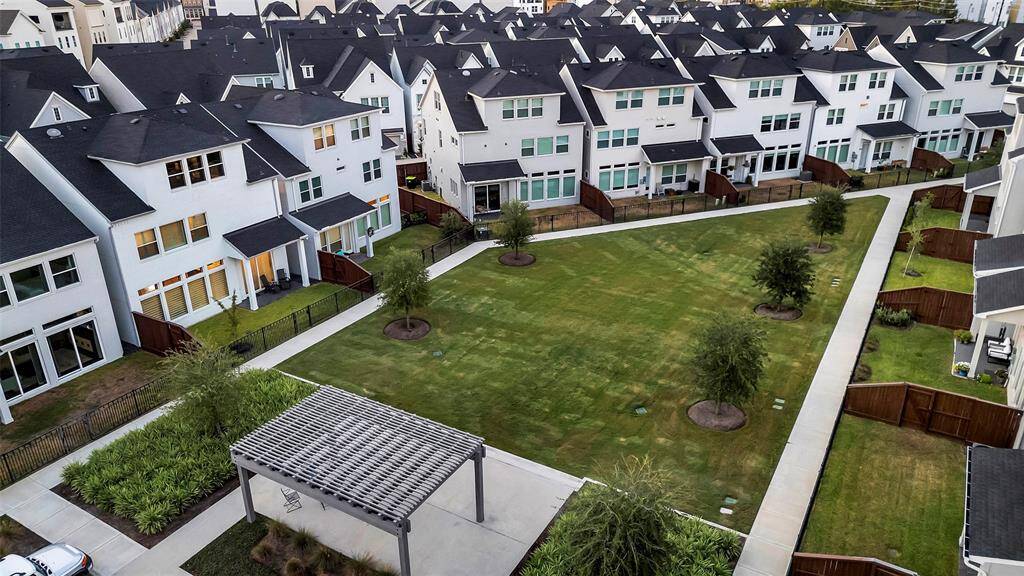 We see our home here second from the bottom of this photo. The green space is both decorative & practical with paths & a pergola with seating to enjoy.
