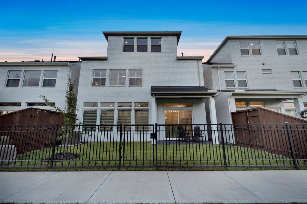 This elegant home is finished in white brick with a beautiful fenced rear yard.