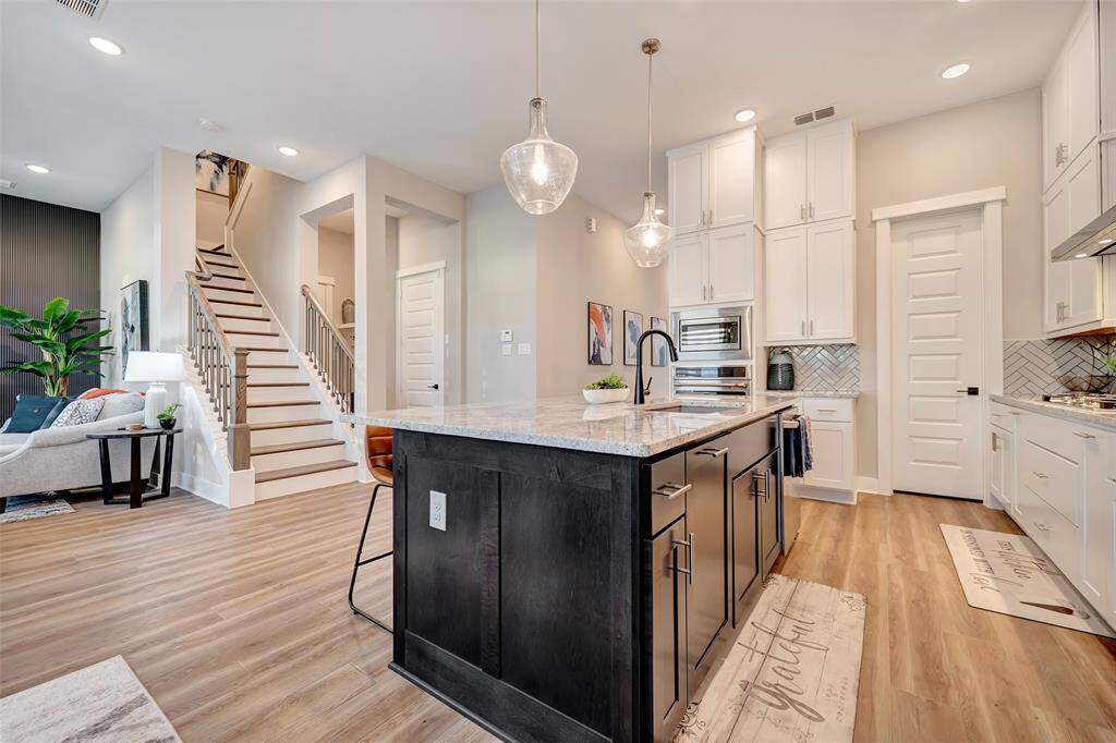 This stunning open plan living design flows effortlessly from home office to kitchen to dining to living spaces. Highly desirable!