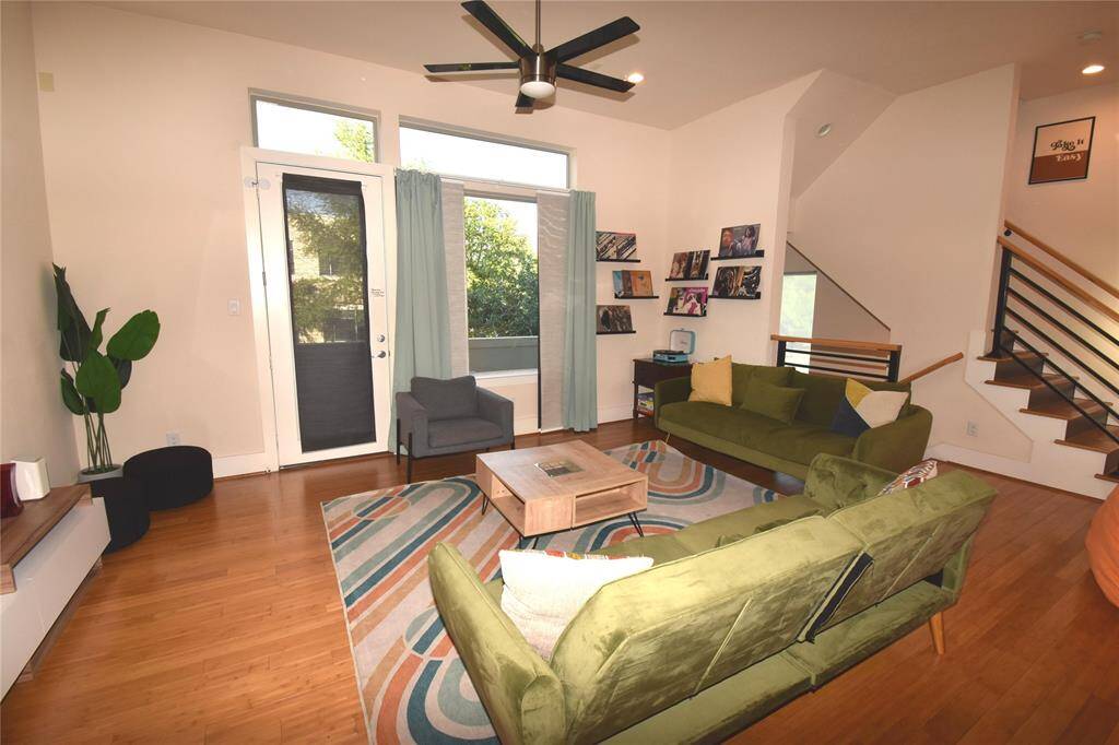 View into family room from kitchen with doorway onto balcony