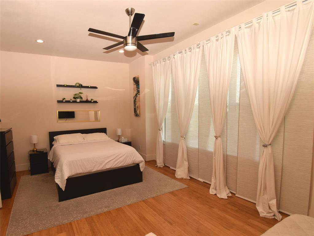 Master bedroom seen from doorway showing expansive windows. All window treatments to remain