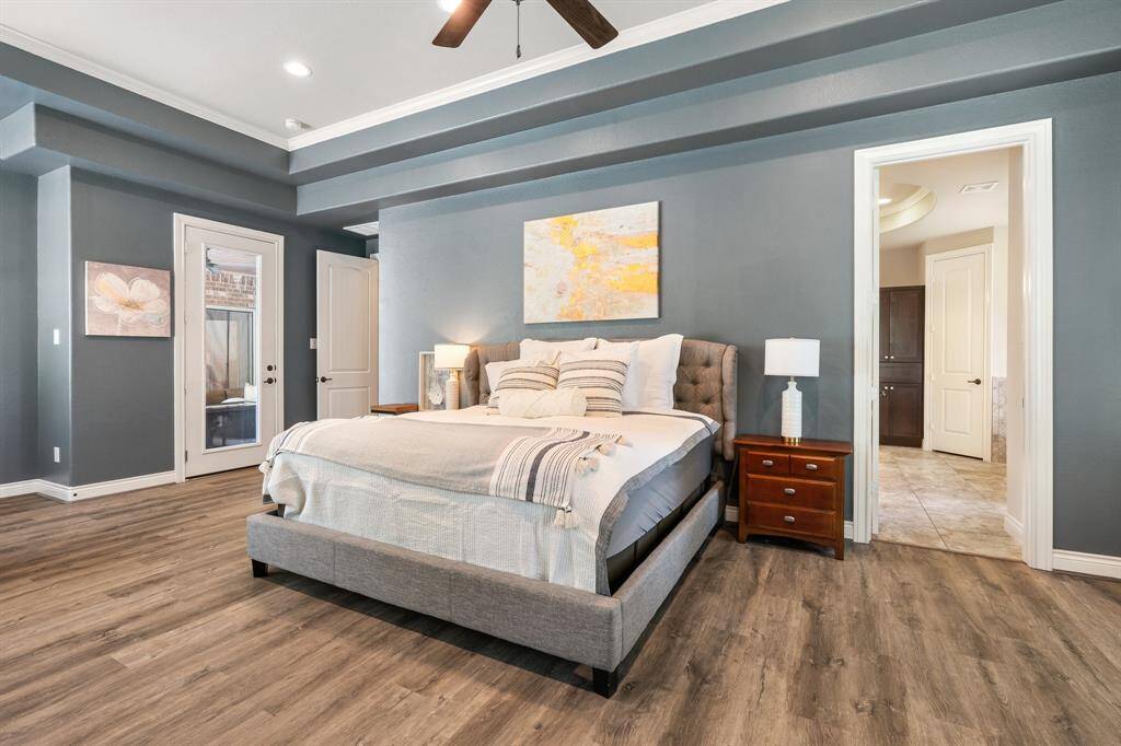 Another view of the primary suite.  The glass door leads out to your private covered back porch that overlooks the pool and spa.  This home has 2 covered porches.