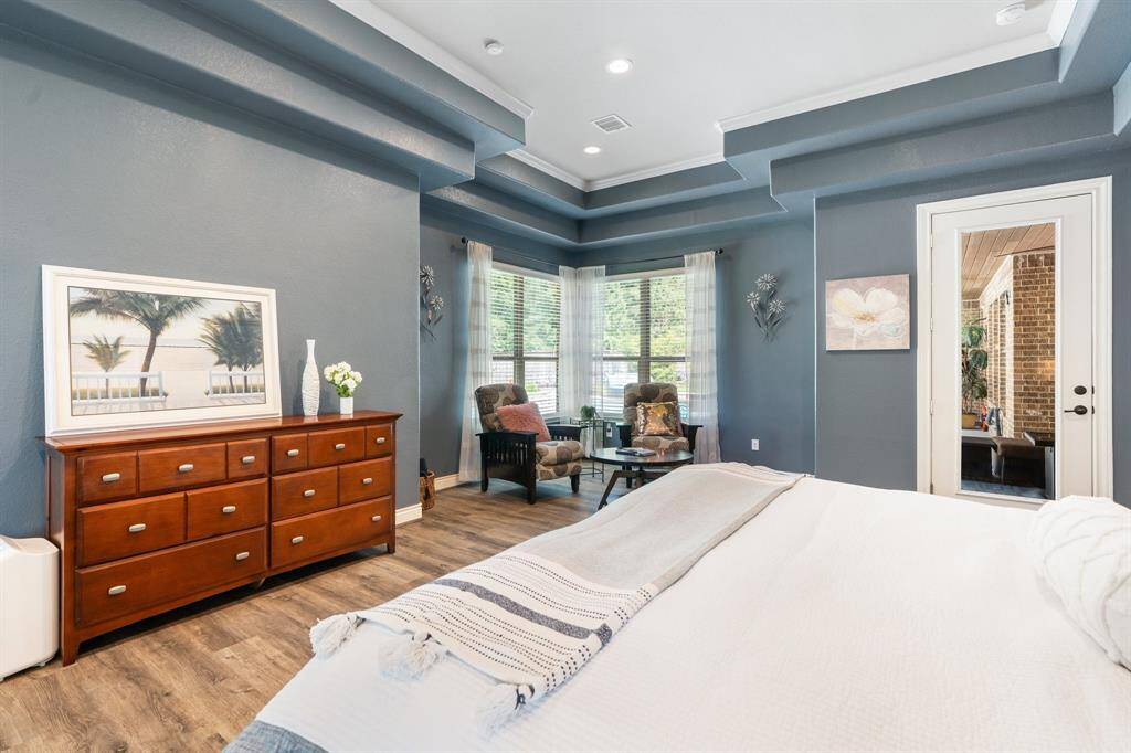 Primary has space for a large seating area with windows providing natural light.  There's a beautiful view of the backyard pool and spa.