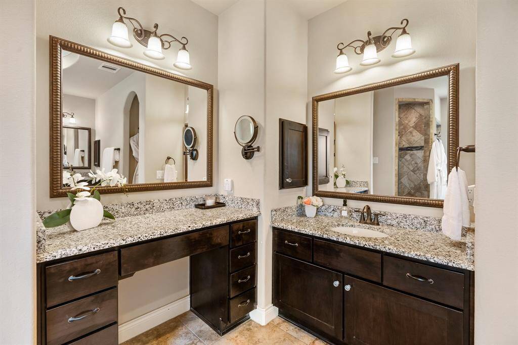 Primary bathroom has 3 separate vanity areas with granite countertops.  There's plenty of space for storing all of your things and being organized.