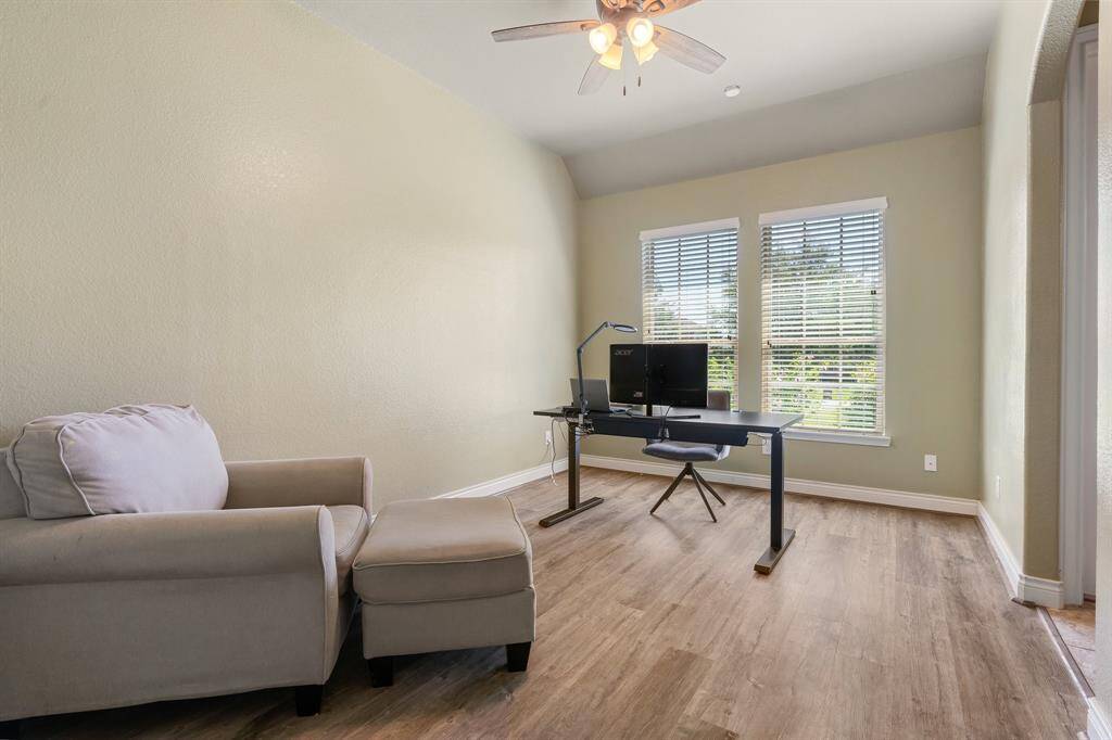 Secondary bedroom located on the front side of the home.  Plenty of natural light, luxury vinyl plank flooring, and ceiling fan.  There's a Jack and Jill bathroom that connects the secondary bedrooms.