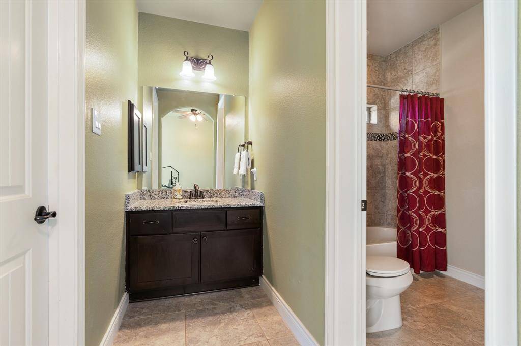 Vanity with granite countertops.