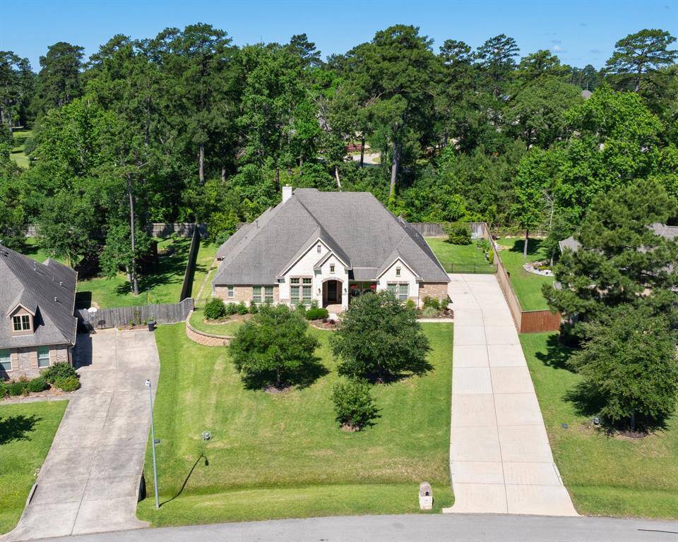 Spacious half acre lot backs to mature trees. Notice the long double wide driveway. No backyard neighbors!