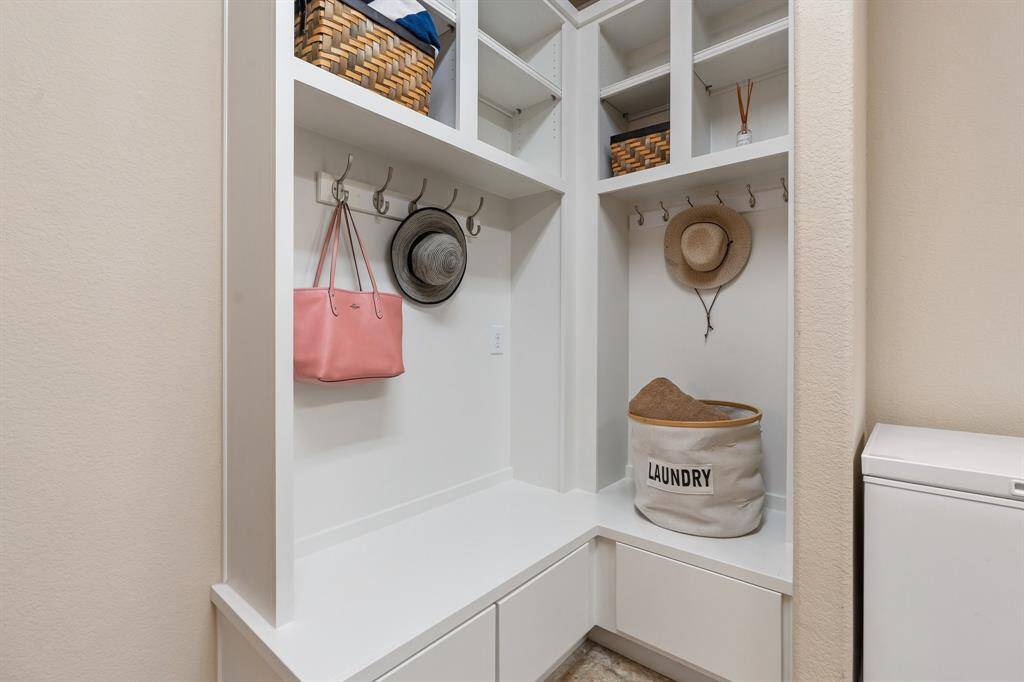 Mud area in the laundry room will keep your family organized.  Hang the kids backpacks, use the drawers for sporting equipment, etc.  The laundry room is conveniently located by the garage making it the perfect catch all.