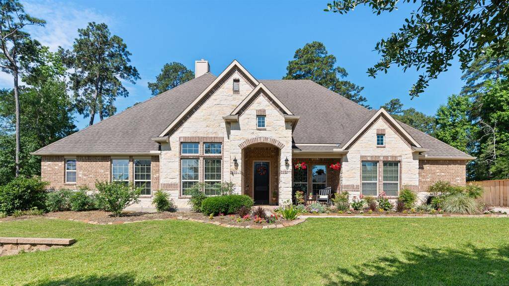 Beautiful front view of 40337 Mostyn Drive. So many beautiful flowers in the flowerbeds. Covered porch to enjoy visiting with friends.