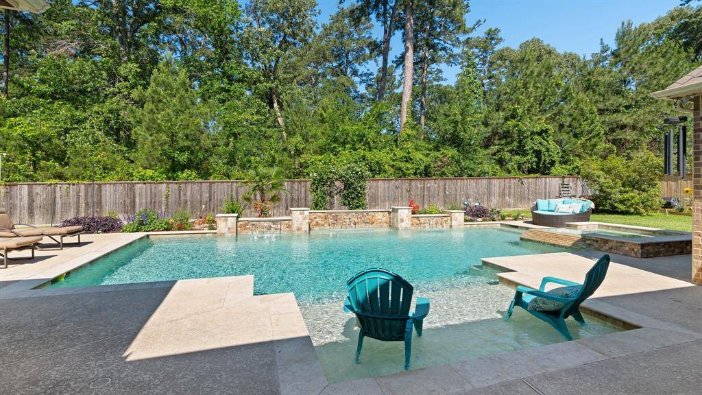 Backyard view has a wall of mature trees.  You almost forget that you have neighbors.  The pool is perfectly situated for privacy.