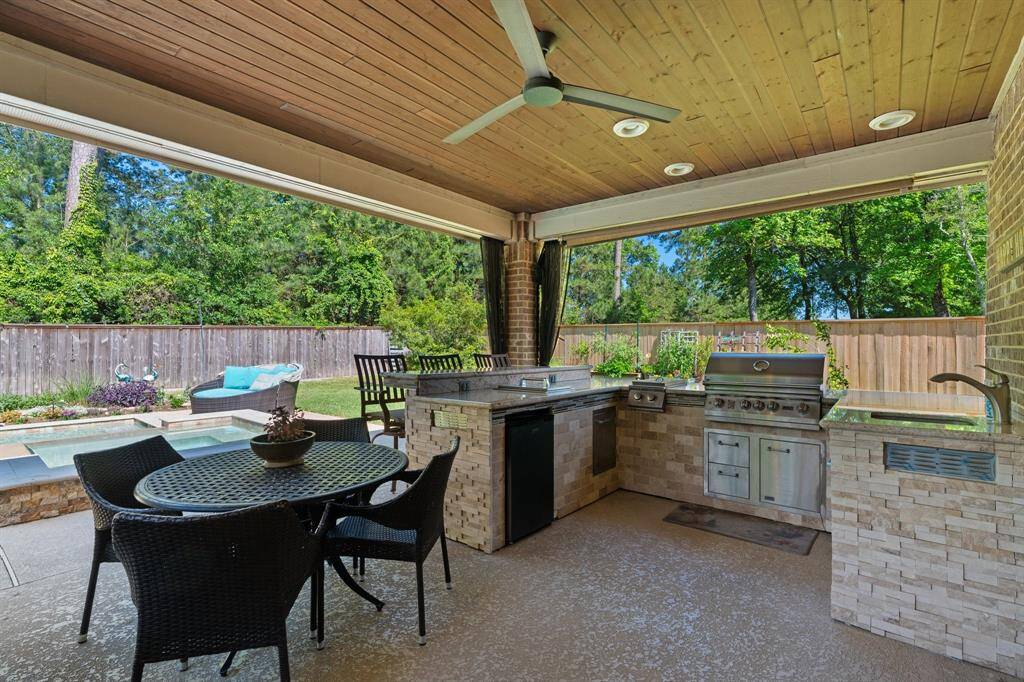 Take note of the tongue and groove wooden ceiling with lights and ceiling fan.  The bar area is a great place to entertain. There's additional space to add a table and chairs.  So much space for entertaining.