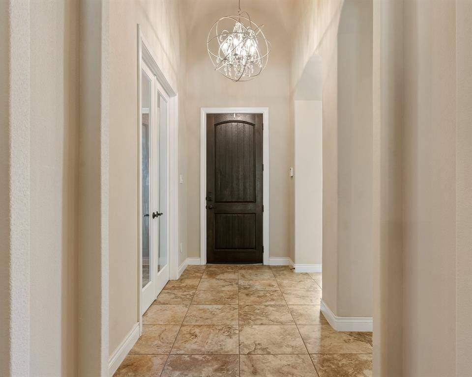 Entryway looking toward the lovely mahogany front door.  Updated chandelier looks beautiful.