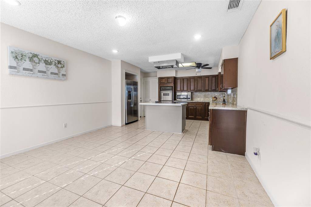 Welcome to a seamlessly designed home where a modern kitchen greets you to your left as you step inside.