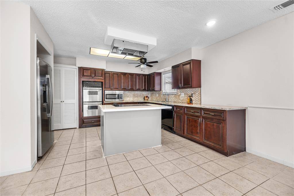 Modern, open-concept kitchen with seamless flow into the dining space, perfect for entertaining.