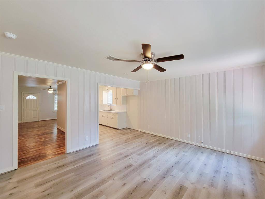 Breakfast area with new flooring, ceiling fan and fresh paint.