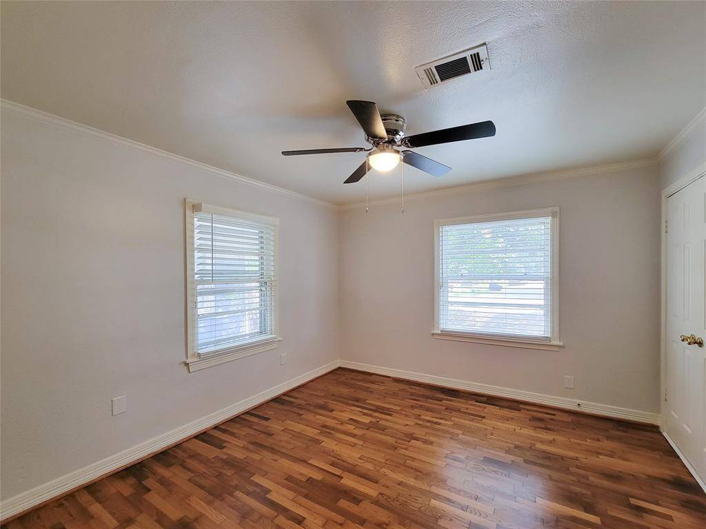 Bedroom 1- fresh paint, recent refinished hardwoods, new ceiling fan and 2 inch faux wood blinds.