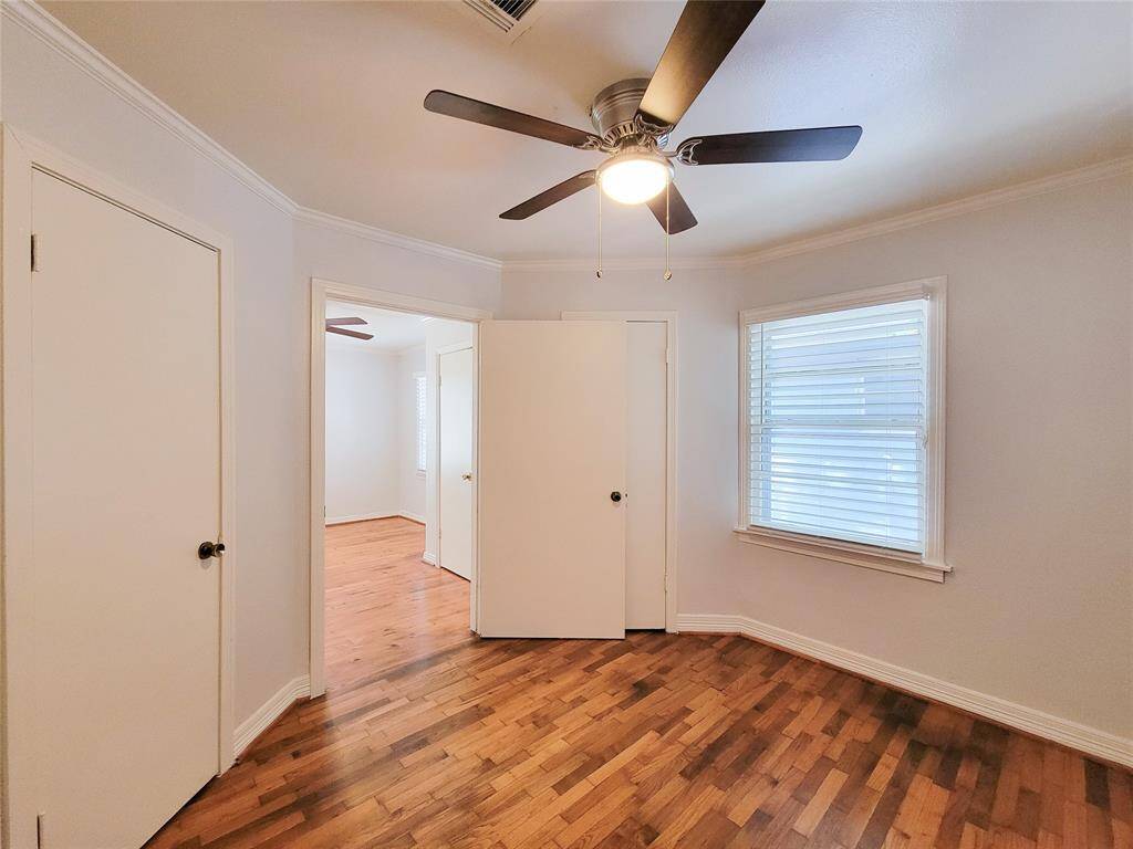 Bedroom 2- 2 closets, fresh paint, recent refinished hardwoods, new ceiling fan and 2 inch faux wood blinds.
