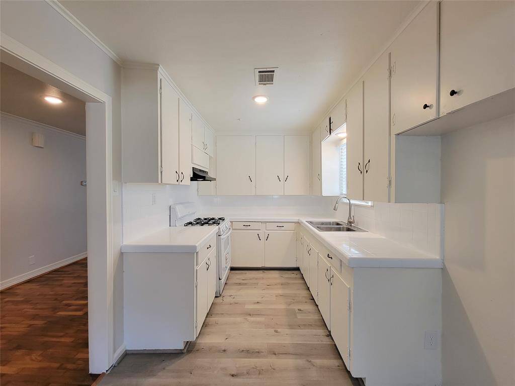 Kitchen features refreshed counters, fresh paint, new range, stainless sink and boast of natural light.