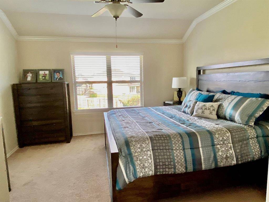 Spacious master bedroom with abundant natural light, featuring a cozy layout and elegant finishes. Perfect for relaxation and comfort.