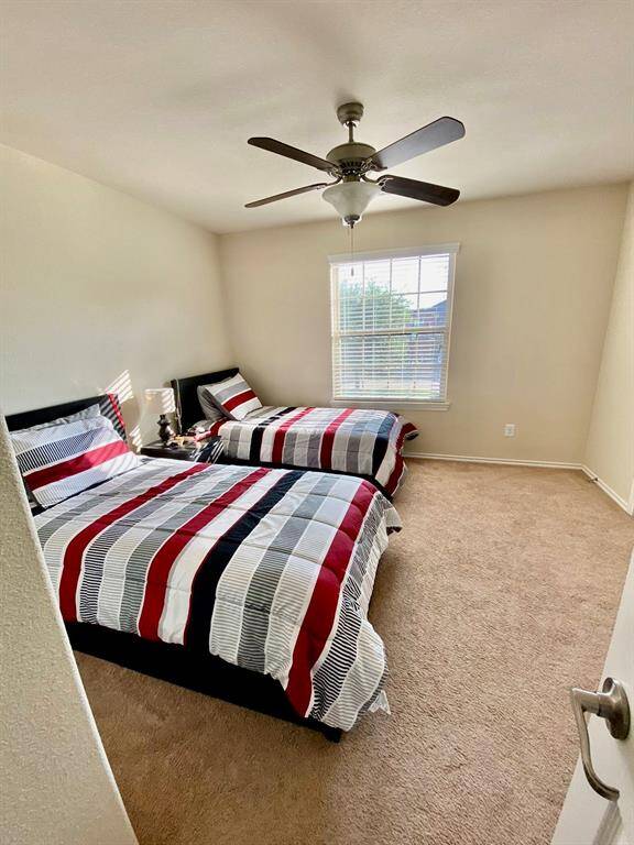 Cozy third bedroom with ample natural light, perfect for guests or a home office.
