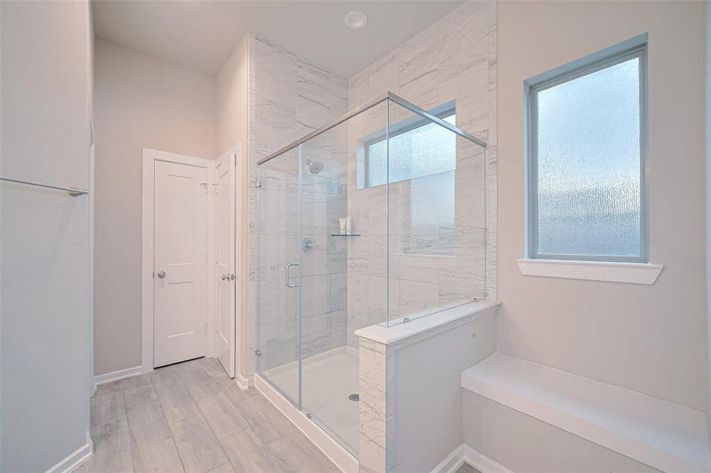 Separate shower and bath tub with plenty of room and natural lights
