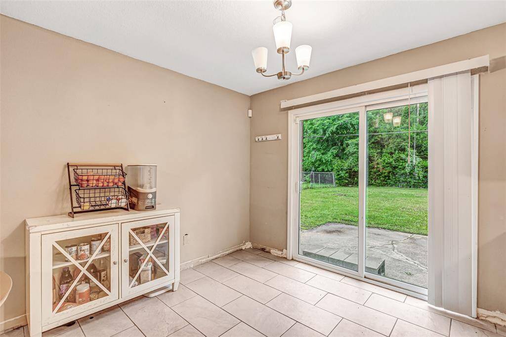 Cozy breakfast nook with natural light and patio access, perfect for morning coffee.