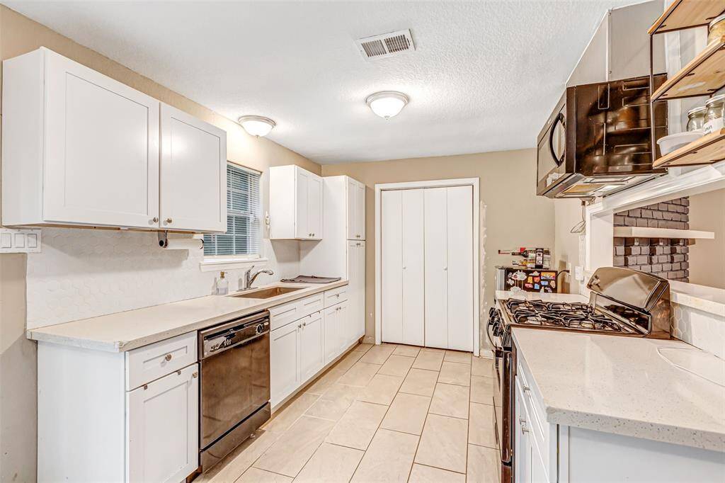 Modern kitchen featuring sleek white cabinetry, stainless steel appliances, and ample counter space. Perfect for culinary enthusiasts.