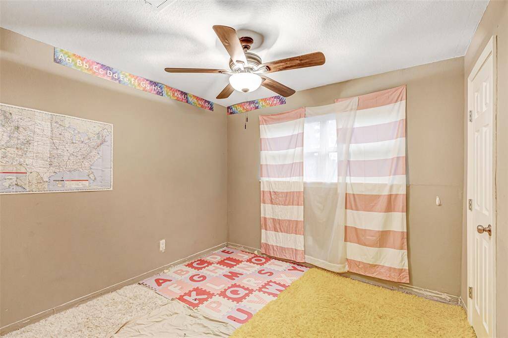 Cozy second bedroom with natural light, perfect for a child's room or home office.