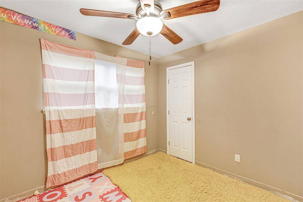 Cozy second bedroom with natural light, neutral tones, and ample closet space. Perfect for guests or a home office.