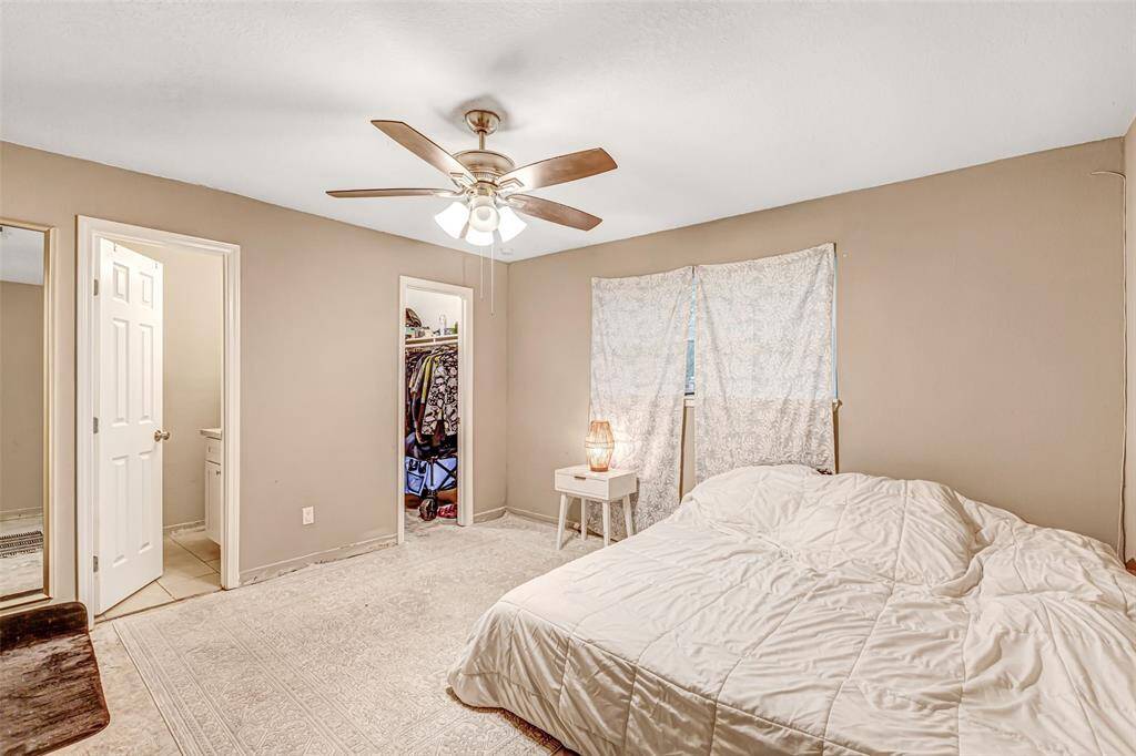 Spacious primary bedroom with ensuite bathroom, walk-in closet, and plenty of natural light for a serene retreat.