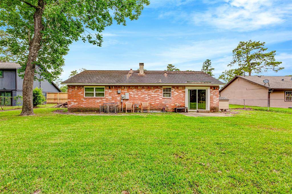 Spacious backyard with a charming brick exterior, perfect for outdoor gatherings and relaxation.
