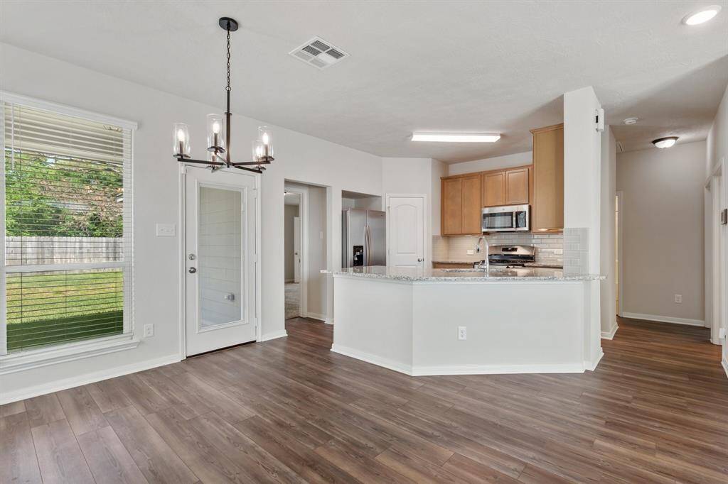 The kitchen is the heart of the home, centrally located between all main living areas, primary suite and secondary bedrooms.