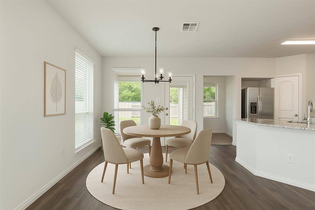 Enjoy backyard views from the dining room and easy access to the covered back patio. This room is virtually staged.