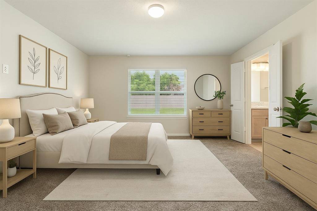 The primary bedroom offers a peaceful retreat, complete with an en-suite bathroom for added convenience. This room is virtually staged.