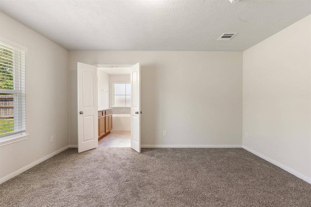 The primary suite offers serene backyard views.