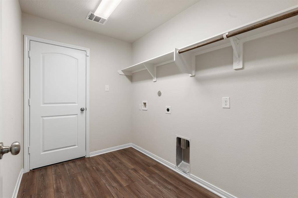 The laundry room is located near the secondary bedroom has access to the 2 car garage.