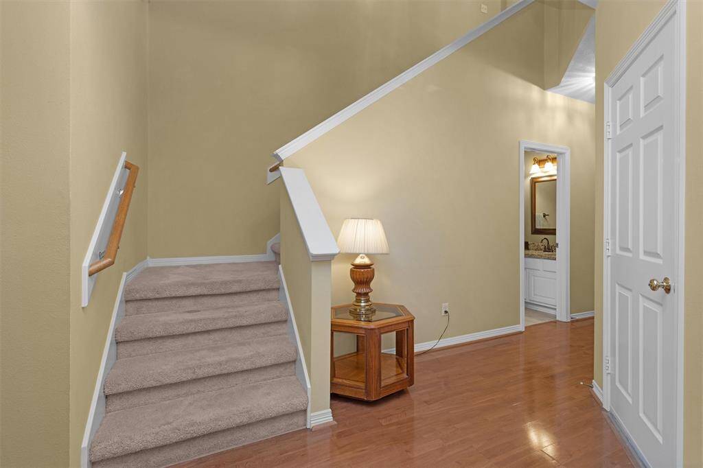 Carpeted stairs lead to bedrooms