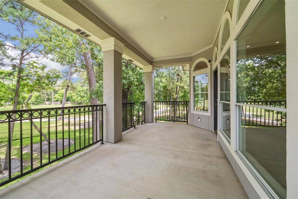 One of two balconies accessible from the family room with a winding black iron staircase leading to the backyard.