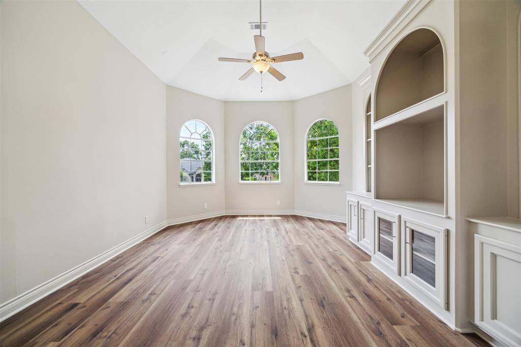 Den located off of the family room and kitchen includes a built-in entertainment center.