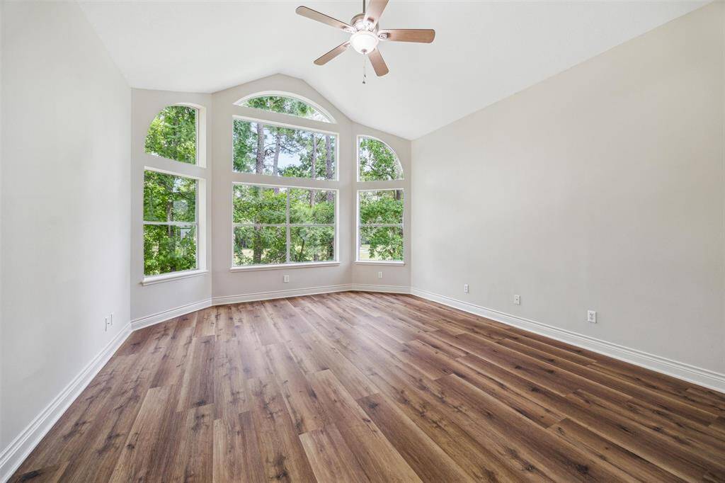 Large primary bedroom features a high ceiling, large windows & access to a second balcony.