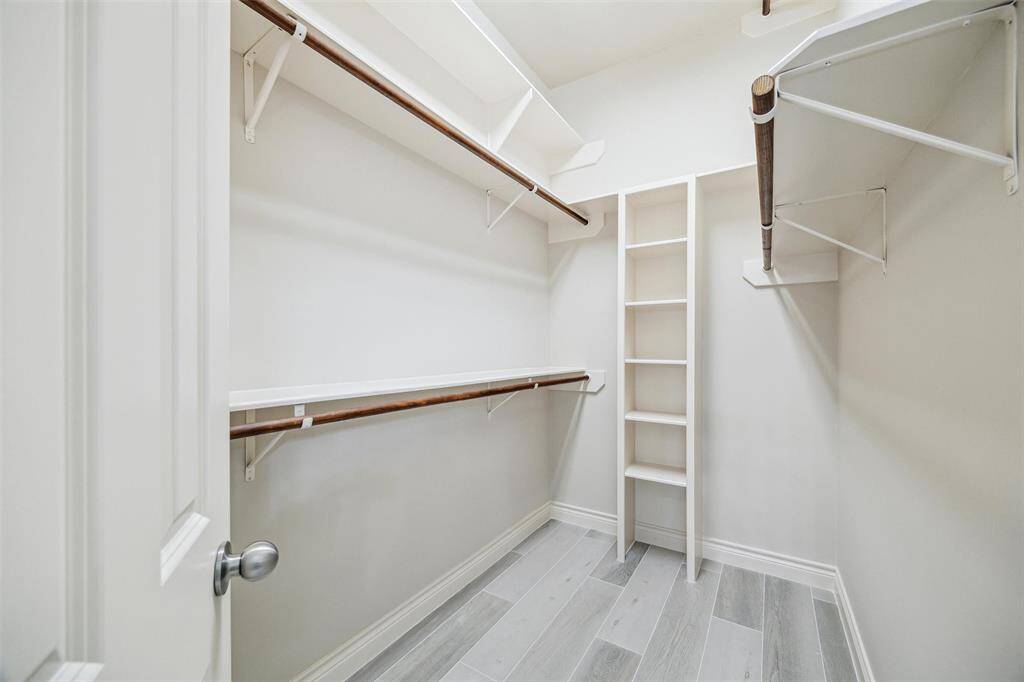 His and hers closet located in primary bathroom