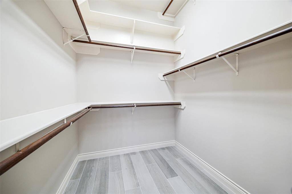 His and hers closet located in primary bathroom