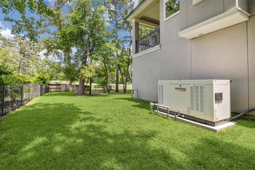View of the side of the home features a 38kw 2.4L Generac Generator.