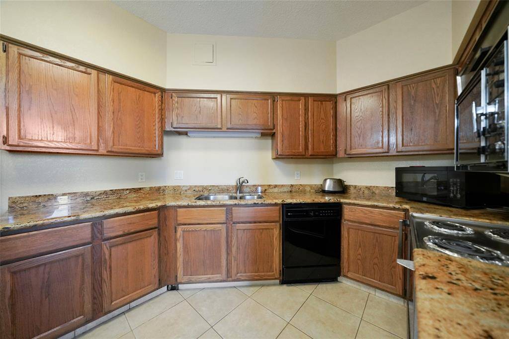 The kitchen features plenty of cabinet space, granite countertops, and a functional layout that makes meal prep easy and convenient.