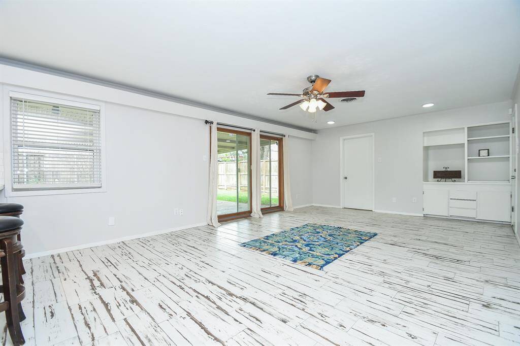 With open wall and floor space everywhere you look, this fabulous living area offers direct access to patio/backyard, with welcomed built in wall shelving.