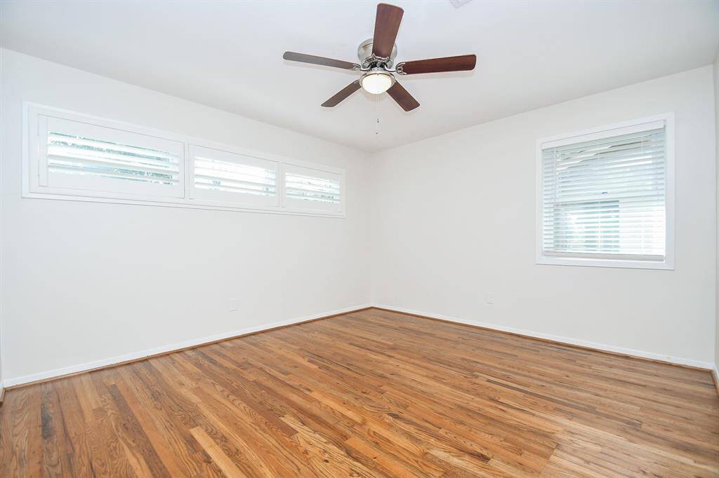 High windows in this bedroom (primary?) offer more wall/floor space for your favorite treasures.