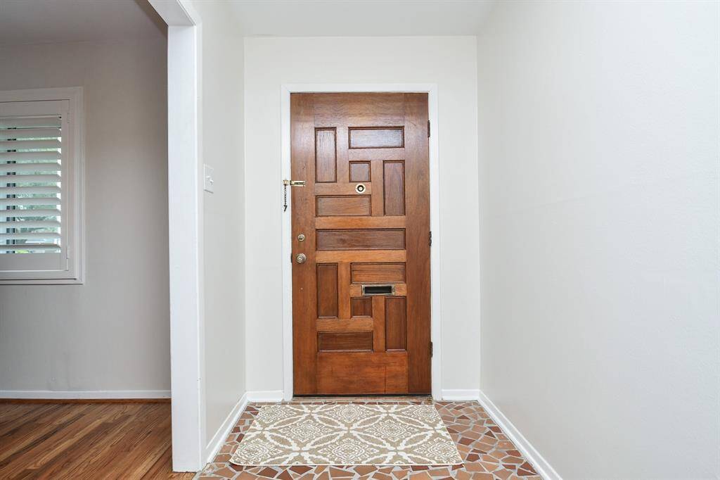 This is your front entry from the inside, with cool, neutral walls, crisp rustic flooring, and good looking tile. The home features 3 bedrooms, 2 baths, all occupying a 6,840 square-foot-lot with 2,022 square-feet of interior living space.